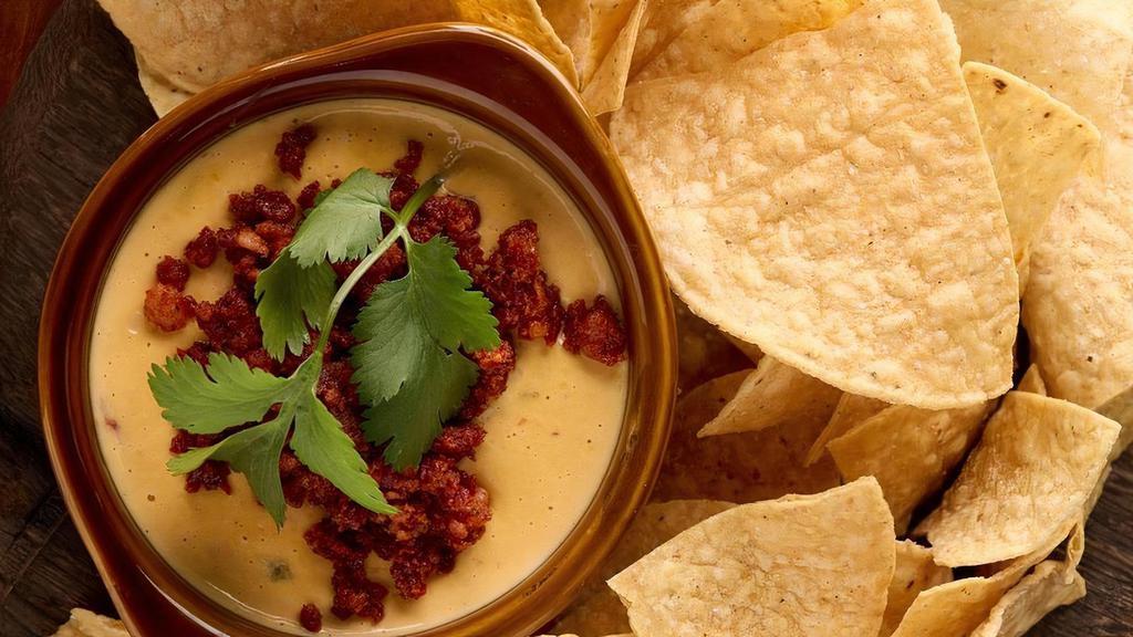 Queso · Three cheese blend, roasted tomato, pickled jalapeño. Served with warm corn tortilla chips. Add chorizo for added flavor (pictured)!. Vegetarian. Gluten-free