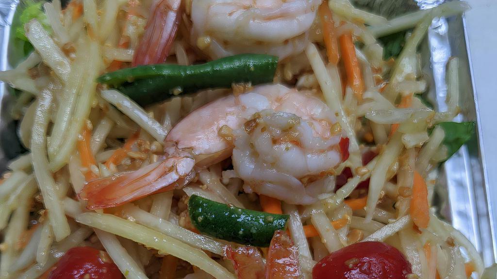 Green Papaya Salad · Gluten free. Hot and spicy. Featuring shredded green papaya with fresh lime juice, caramelized palm sugar shrimps, tomatoes, green bean, grounded peanut, carrot and chili lime dressing.