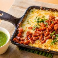 Queso Fundido Con Chorizo · Oaxaca and chihuahua cheeses baked with chorizo and served with soft corn tortillas and fres...