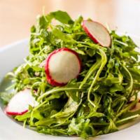 Ensalada Fonda · Arugula, radishes and red onions. Tossed with a simple lemon and olive oil vinaigrette.