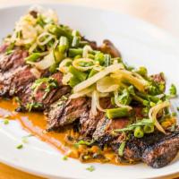 Carne Asada Con Hongos · Grilled skirt steak with corn mushroom sauce, served with green bean escabeche.