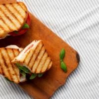 Mediterranean Panini · Crispy, buttery, pressed sandwich loaded with fresh spinach, tomatoes and roasted peppers, f...