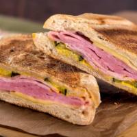 Cubano Panini · Crispy, buttery, pressed sandwich loaded with slow roasted pork, ham, Swiss cheese, pickles ...