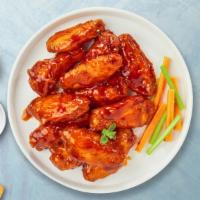 Buffalo Blow Wings · Fresh chicken wings breaded, fried until golden brown, and tossed in buffalo sauce. Served w...