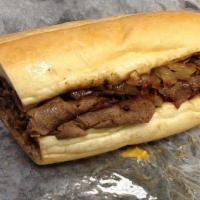 Philly Cheese Steak Sandwich · Grilled rib eye with fried onions and melted American cheese.