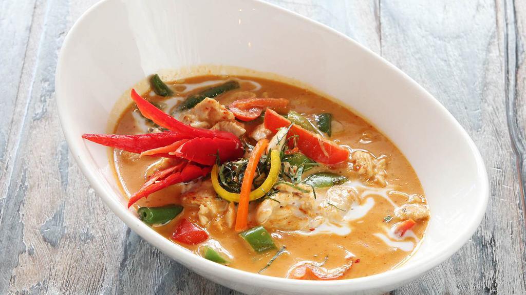 Panang Curry (L) · Hot, gluten free. Spices and herbs blended in chili paste with string beans, peppers, potatoes, carrots, peanut paste and kaffir lime leaves, simmered in coconut milk.