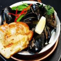 Thai Steamed Mussels · Prince Edward Island mussels, onion, bell pepper, Thai basil leaves and spicy Thai herbs. Sp...
