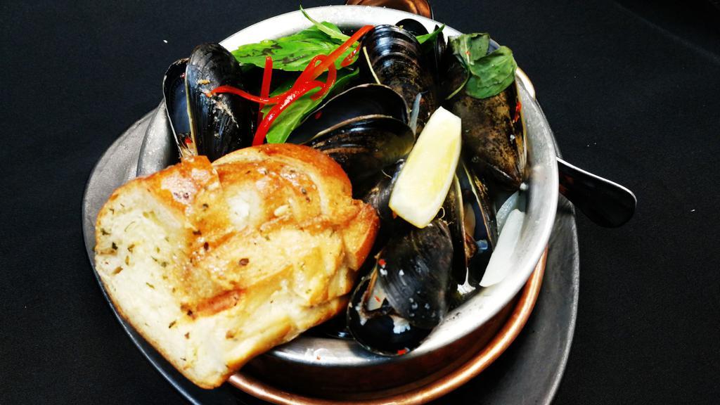 Thai Steamed Mussels · Prince Edward Island mussels, onion, bell pepper, Thai basil leaves and spicy Thai herbs. Spicy.