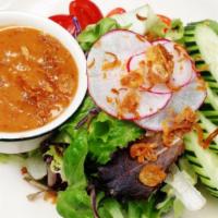 Thai Salad · Gluten free. Fresh greens with tomatoes, cucumber and bean curd. Served with peanut dressing.