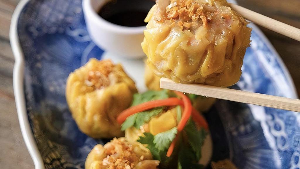 Steamed Dumplings · Ground chicken and shrimp, water chestnuts and shiitake mushrooms served with tangy soy sauce.