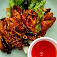 Thai-Herbed Wings · Golden-fried chicken wings topped with crispy thai herbs and served with sweet chili sauce.