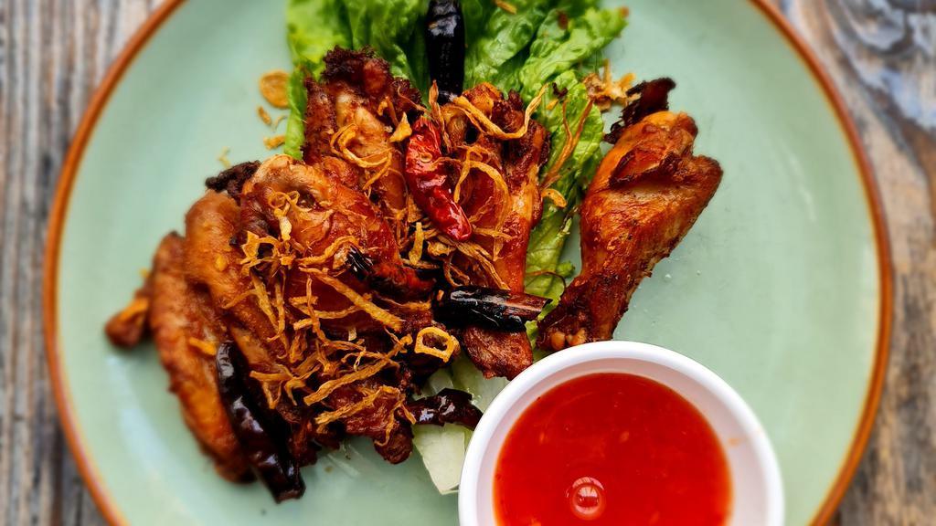 Thai-Herbed Wings · Golden-fried chicken wings topped with crispy thai herbs and served with sweet chili sauce.