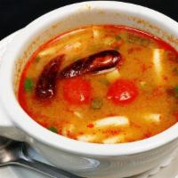 Tom Yum Soup · Lemongrass broth, king mushrooms, tomatoes, scallions and cilantro. Spicy.