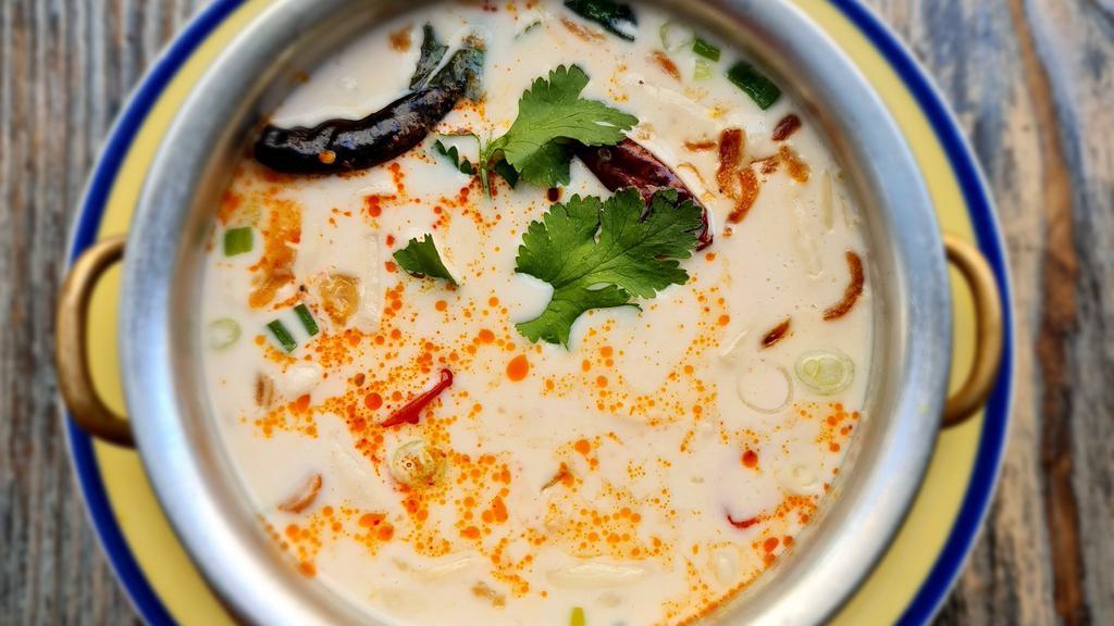 Tom Kha Soup · King mushrooms and scallions, in coconut galangal broth. Spicy.