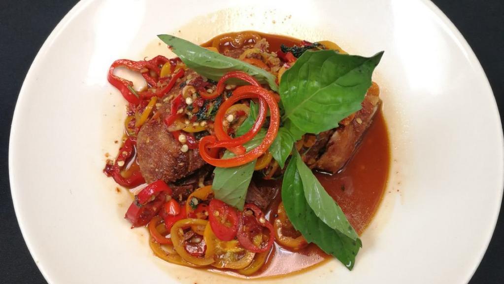Duck Basil · Crispy duck breast,  Thai chili, mini bell pepper, and thai basil leaves. Served with jasmine white rice. Spicy.