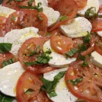 Caprese Salad · Fresh mozzarella, tomato, olive oil, basil, and spices.