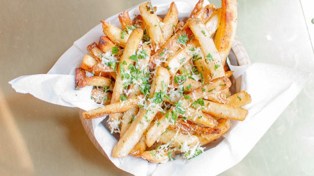 Truffle Fries · Tossed in 5 months aged grated Parmesan cheese, parsley, and black truffle oil drizzle.