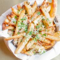 Truffle Fries · Tossed in 5 months aged grated Parmesan cheese, parsley, black truffle oil drizzle.