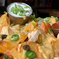 Hooligans Nachos · A heaping portion of homemade tortilla chips, Cheddar jack cheese, black olives, jalapeños, ...