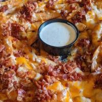 Loaded Fries · A huge portion of our delicious french fries topped Cheddar jack cheese, crumbled bacon, and...
