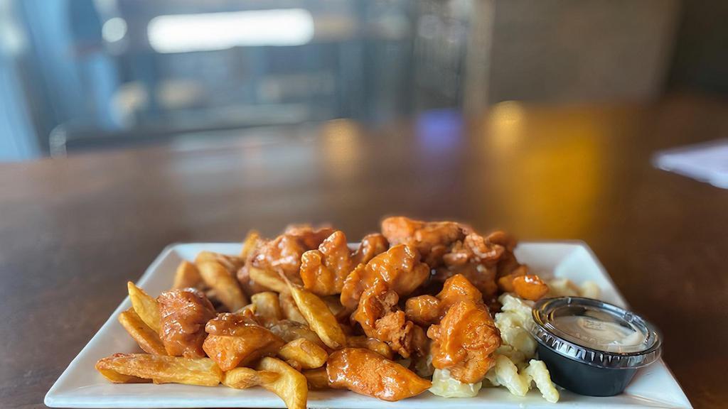 Boneless Wing Platter · An order of our boneless wings tossed in a wing sauce of your choice over macaroni salad and french fries. Served with blue cheese.