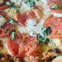 Margherita Pizza · Fresh tomatoes, fresh mozzarella, basil, olive oil, and garlic.