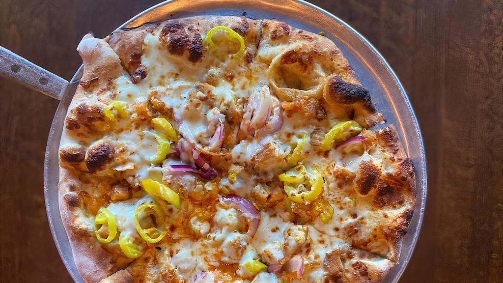 Buffalo Chicken Pizza · Mild wing sauce, chicken tenders, banana peppers, red onion, mozzarella, and crumbled blue cheese.