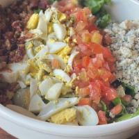 Cobb Salad · Romaine hearts, tomato, hardboiled egg, crispy bacon, and crumbly blue cheese. Served with y...