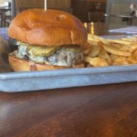 Frickle Burger · Topped with our fried pickle chips, sliced red onion, Monterey jack cheese, and topped with ...