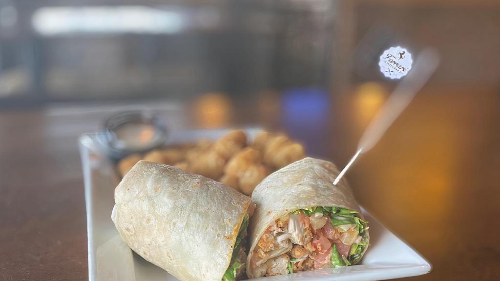 Buffalo Chicken Wrap · Grilled or crispy chicken tossed in your choice of buffalo sauce, lettuce, tomato, and Cheddar jack cheese. Served with blue cheese for dipping. Served with a side of French fries.