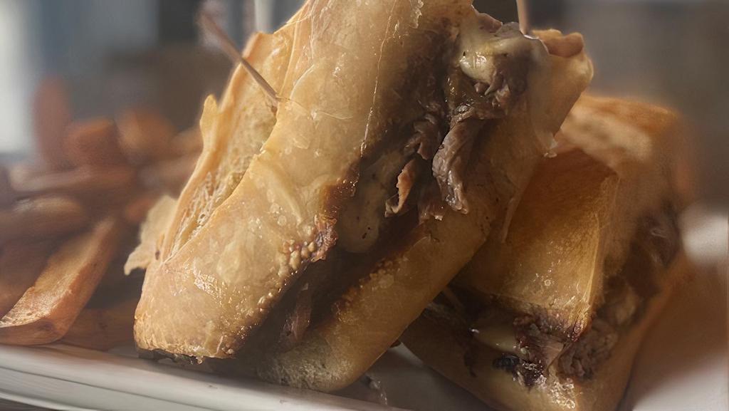 French Dip Sandwich · House cooked roast beef, sliced to order, with caramelized onions, and provolone cheese. served with a shot of french onion soup for dipping. Served with a side of French fries.