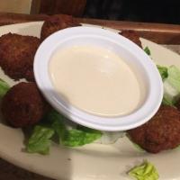 Falafel · Croquettes of ground chickpeas and spices served with tahini sauce.