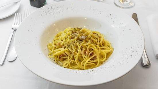 La Carbonara · Spaghetti, smoked pancetta, egg yolk, onions and pecorino romano.