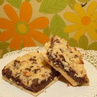 Yum-Yum Bars · Shortbread crust layered with semi-sweet chocolate chips, raspberry preserves with a shortbr...