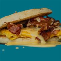 Bacon, Egg & Cheese Sandwich · Three strips of bacon, scrambled eggs, and American cheese on a toasted English muffin. Hous...
