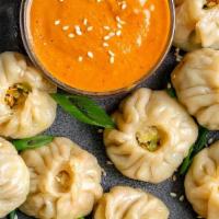 Steamed Veg Momo · Grated carrot, cabbage, chopped onion, garlic -together spiced and filled in small pocket sh...