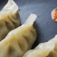 Chicken Momo With Spicy Sauce · Chopped green chili, onion, garlic, combine with minced chicken and filled in pocket shell m...