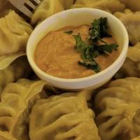 Veg Momo  With Spicy Sauce  · Grated carrot, cabbage, chopped onion, garlic -together spiced and filled in pocket then ste...