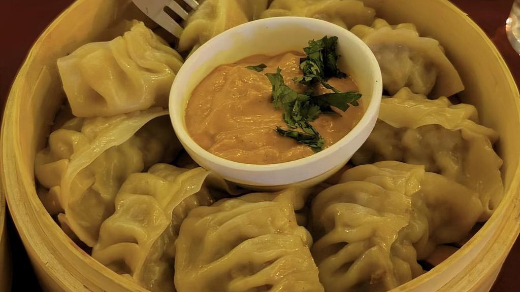 Veg Momo  With Spicy Sauce  · Grated carrot, cabbage, chopped onion, garlic -together spiced and filled in pocket then steamed/fried and Served spicy(Veg).