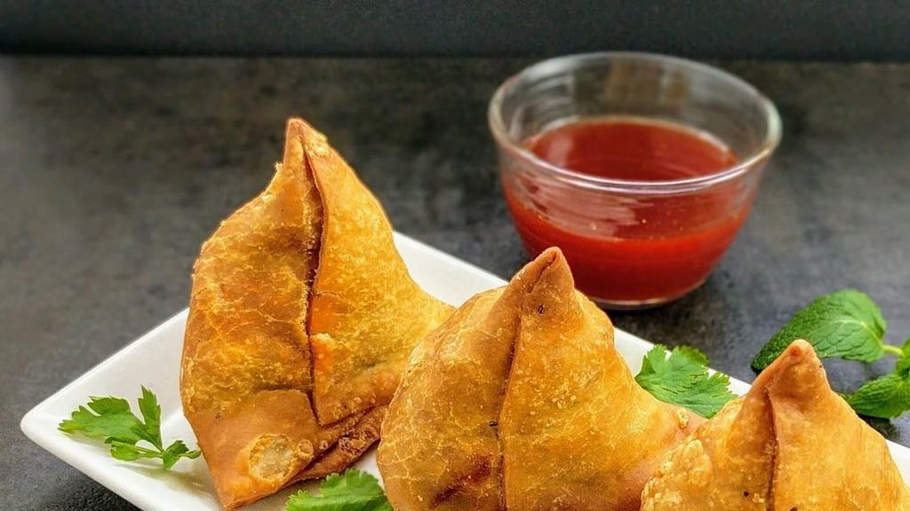 Samosa · Crispy Pastry Stuffed With Spiced Potatoes And Peas.