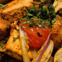 Chicken Tikka · Skewered Strips Of Boneless Chicken Marinated In Herbs, Spices, And Yogurt, Grilled In The C...