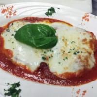 Eggplant Parmgiano · Breaded eggplant topped with mozzarella cheese and tomato sauce.