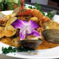 Risotto Mare · Italian rice with shrimp, mussels, calamari, scallops and clams in light pink sauce.