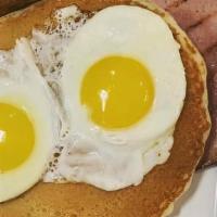Breakfast Sampler · Two Eggs, Pork Sausage, Bacon, Ham, and Short Stack Buttermilk Pancakes.