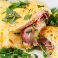Decadent Ham And Cheese Omelette · Sunny 3-egg omelette with ham, mushrooms, diced onion, and your choice of cheese. Side of to...