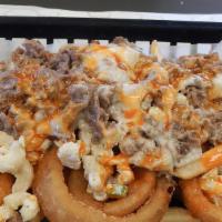 The Philly Plate · With cheese served over a bed of mac salad, onion rings and French fries. Smothered in hot s...