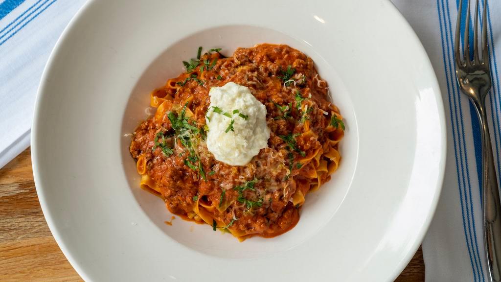 Pappardelle Bolognese · Classic meat ragu, fresh herbs, ricotta cheese.