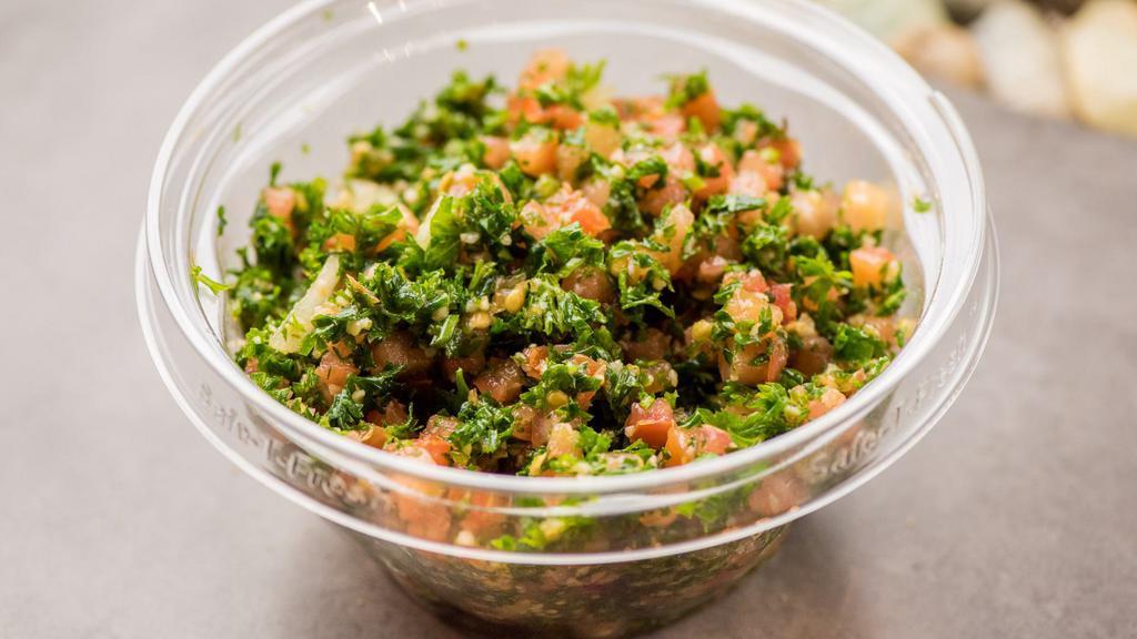 Taboule Salad · Vegetarian, Vegan. Fresh parsley, wheat bulgur, tomatoes, onions, lemon juice, and olive oil.