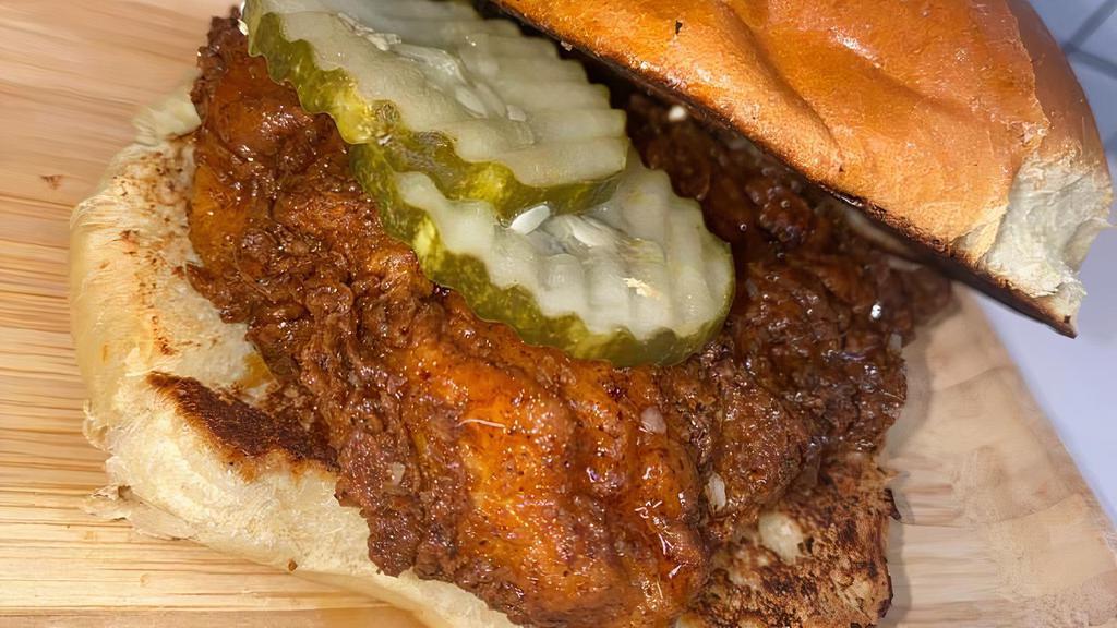 #2 Hot Honey Chicken Sandwich · Crispy fried hot chicken breast sandwich, served with glazed, sweet hot honey sauce and pickles.