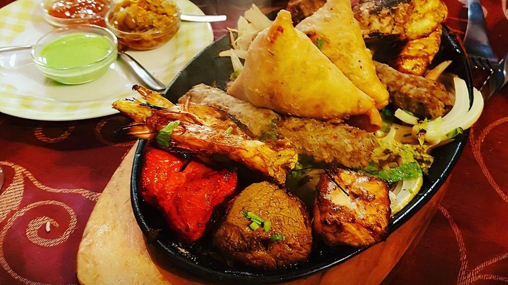 Kashmiri Combination Platter · Brown rice w/ Chicken Kabab, Chicken tikka, Shaami kabab, lamb chops, & nan bread.

Served with salad, and dressing.